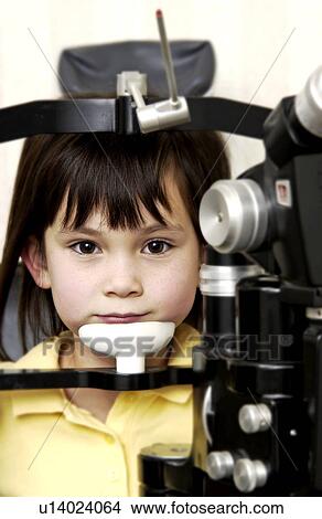 Picture - Girl getting vision tested. Fotosearch