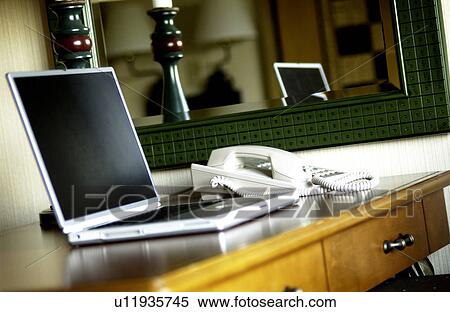 Laptop on desk View Large Photo Image Stock Photography - Laptop on desk. Fotosearch