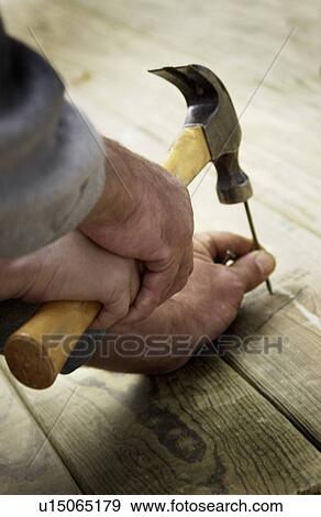 Stock Photo - Man hammering. Fotosearch