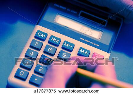Man using calculator View Large Photo Image Stock Photography - Man using calculator. Fotosearch
