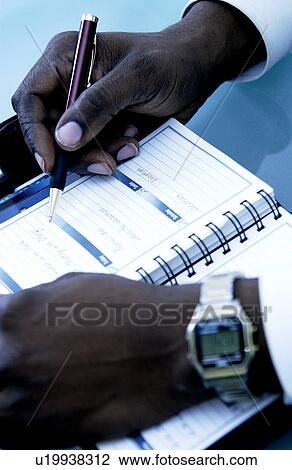 Man writing in daily planner View Large Photo Image Stock Image - Man writing in daily planner. Fotosearch