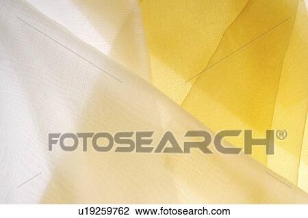 Stock Image - Sheer white and yellow fabric. Fotosearch