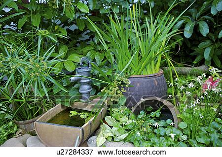 Stock Photo - Corner of garden with pots. Fotosearch