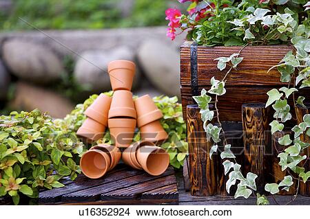 Picture - Robot made of clay pots in garden. Fotosearch