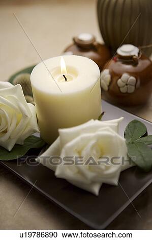 Stock Image - Burning aroma candle. Fotosearch