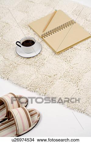 Coffee and notebook on carpet View Large Photo Image Picture - Coffee and notebook on carpet. Fotosearch