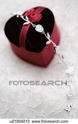 Stock Image - Heart-shaped box with a silver bracelet. Fotosearch