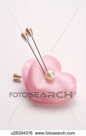 Heart-shaped pin cushion View Large Photo Image Stock Photograph - Heart-shaped pin cushion. Fotosearch