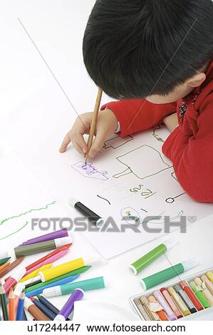 Boy drawing on paper with pencil and color pens View Large Photo Image Stock Photo - Boy drawing on paper with pencil and color pens. Fotosearch