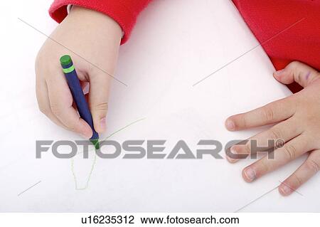 Stock Image - Child drawing on paper with crayon. Fotosearch