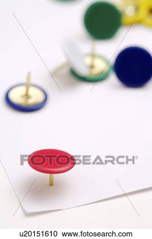 Stock Image - Colorful thumbtack on a sheet of paper. Fotosearch