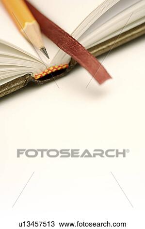 Stock Image - Pencil on notebook. Fotosearch