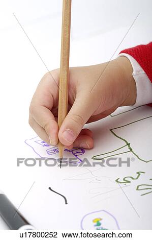 Stock Image - Young boy drawing on paper. Fotosearch