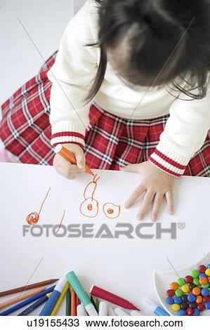 Stock Image - Young girl drawing on paper. Fotosearch