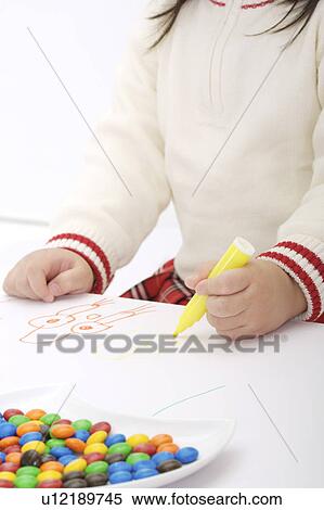 Stock Photography - Young girl drawing on paper. Fotosearch