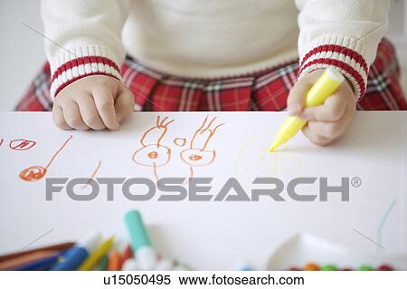 Stock Photography - Young girl drawing on paper. Fotosearch