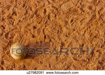 Stock Image - Ball on baseball diamond. Fotosearch