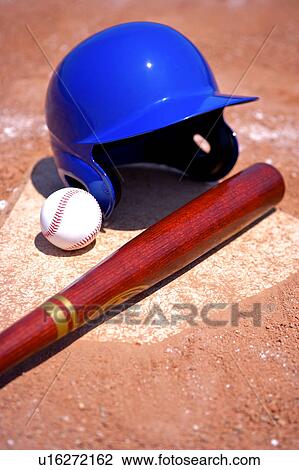Stock Image - Baseball bat, cap and ball on home base. Fotosearch