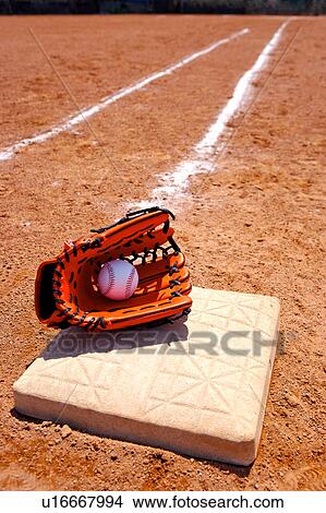 Picture - Baseball glove and ball on base. Fotosearch