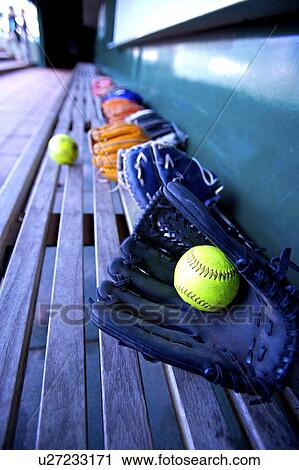 Baseball gloves and balls on bench in dugout View Large Photo Image Stock Image - Baseball gloves and balls on bench in dugout. Fotosearch