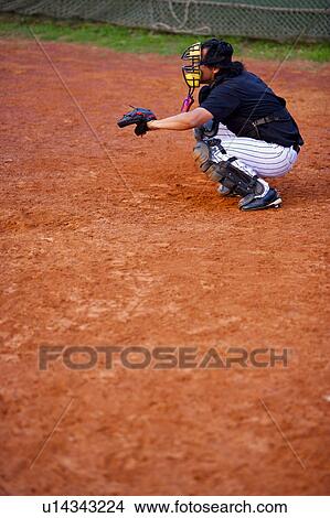 Picture - Baseball player crouching on baseball diamond. Fotosearch