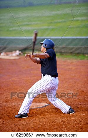 Baseball player holding baseball bat View Large Photo Image Stock Photo - Baseball player holding baseball bat. Fotosearch