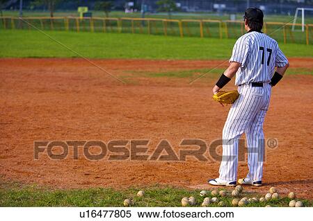 Baseball player standing on baseball diamond relaxing View Large Photo Image Stock Photography - Baseball player standing on baseball diamond relaxing. Fotosearch