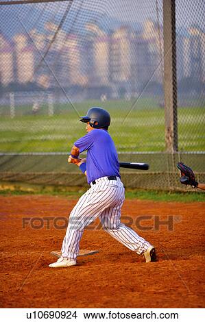 Picture - Baseball player swinging bat. Fotosearch