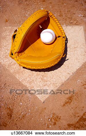 Close up of baseball glove and ball on home base View Large Photo Image Picture - Close up of baseball glove and ball on home base. Fotosearch
