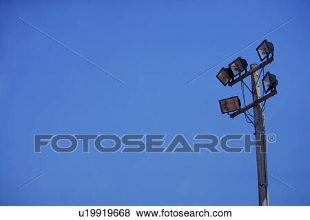 Close up of floodlight against blue sky View Large Photo Image Stock Photo - Close up of floodlight against blue sky. Fotosearch