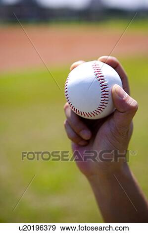 Stock Photo - Hand holding baseball. Fotosearch