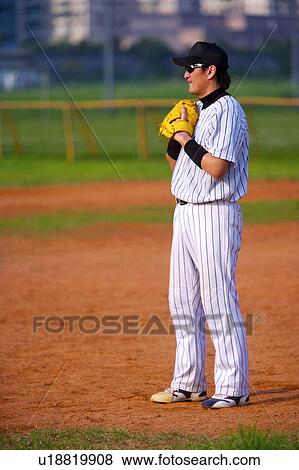 Man standing in baseball diamond View Large Photo Image Stock Photo - Man standing in baseball diamond. Fotosearch