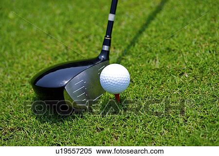 Stock Photography - Close-up of a golf club, a golf ball and a tee . Fotosearch