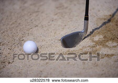 Close-up of a golf club and a golf ball in sand trap View Large Photo Image Stock Photo - Close-up of a golf club and a golf ball in sand trap . Fotosearch