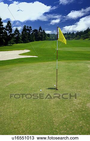 Stock Image - Flag on putting green. Fotosearch