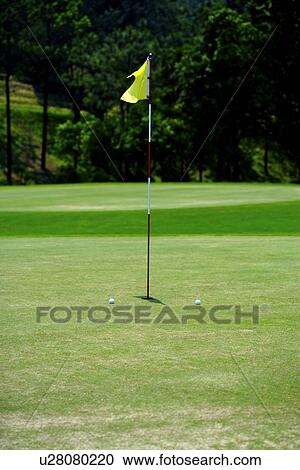 Stock Image - Flag on putting green. Fotosearch
