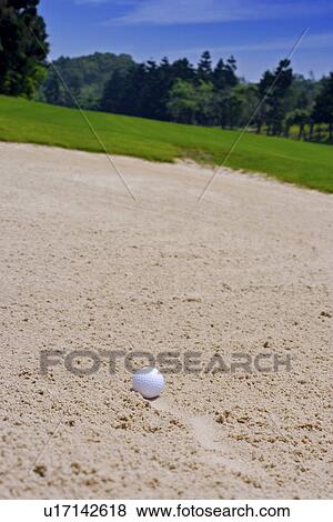Stock Photo - Golf ball on bunker. Fotosearch