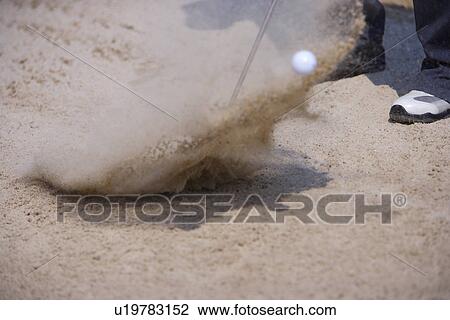 Man hitting golf ball out of sand trap, low section (blurred motion) View Large Photo Image Stock Image - Man hitting golf ball out of sand trap, low section (blurred motion). Fotosearch