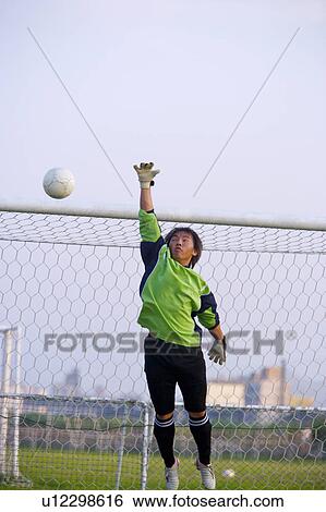 Football goalie diving for ball View Large Photo Image Stock Photograph - Football goalie diving for ball . Fotosearch