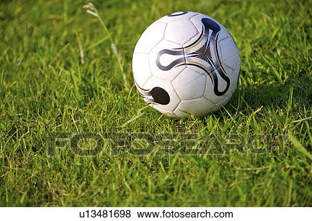 Stock Photo - Soccer ball on grass. Fotosearch