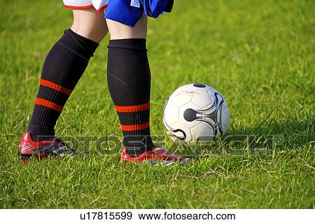 Stock Photo - Soccer player and ball, mid section. Fotosearch