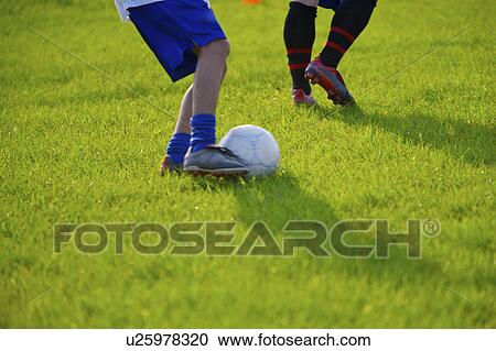 Stock Image - Soccer players, mid section. Fotosearch