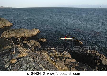 Man kayaking off rocky shoreline, Sheringham Point Lighthouse, Sooke, BC, Canada View Large Photo Image Stock Image - Man kayaking off rocky shoreline, Sheringham Point Lighthouse, Sooke, BC, Canada. Fotosearch