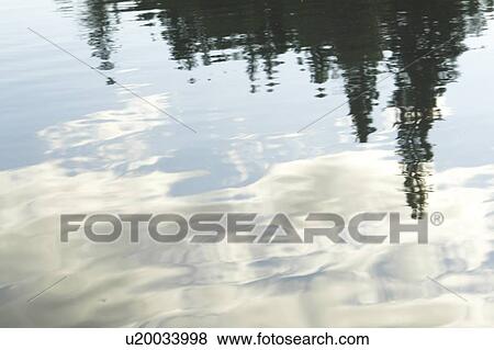Stock Photo - Reflection of clouds in Clear Lake, Riding Mountain National Park; Canada. Fotosearch