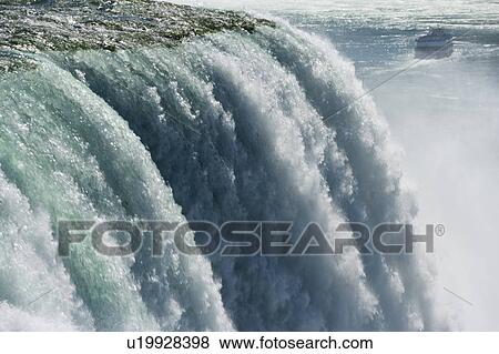 Stock Photo - The American Falls photographed from Prospect Point - Niagara Falls State Park - Niagara Falls New York USA with the Maid of the Mist in the background, USA, New York, Niagara Falls. Fotosearch