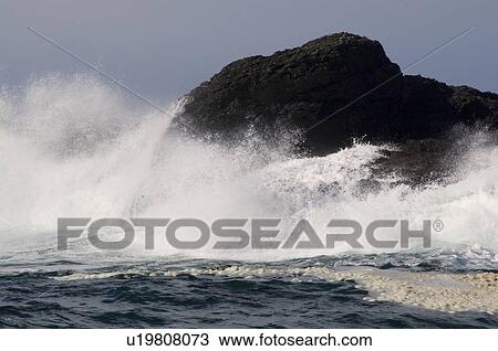 Stock Image - Waves crashing on rocks, Chesterman Beach, Tofino, Vancouver Island, BC. Fotosearch