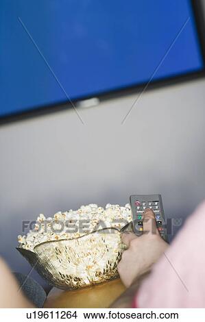 Channel Changer, popcorn and Plasma TV, B. C. View Large Photo Image Picture - Channel Changer, popcorn and Plasma TV, B. C.. Fotosearch