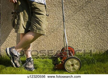 Legs of person beside reel mower, Regina, Saskatchewan. View Large Photo Image Stock Photograph - Legs of person beside reel mower, Regina, Saskatchewan.. Fotosearch
