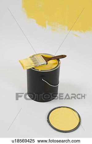 Stock Photography - Open paint can, lid, colour swatch and brush, Canada, British Columbia. Fotosearch