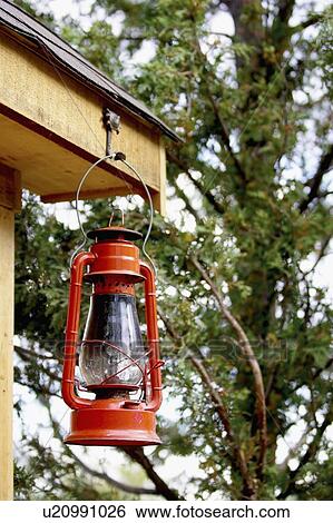 Stock Photograph - Red lantern hanging from corner of shed. Fotosearch